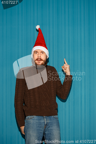 Image of Surprised christmas man wearing a santa hat