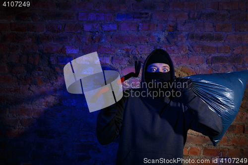 Image of Astonished thief at near wall