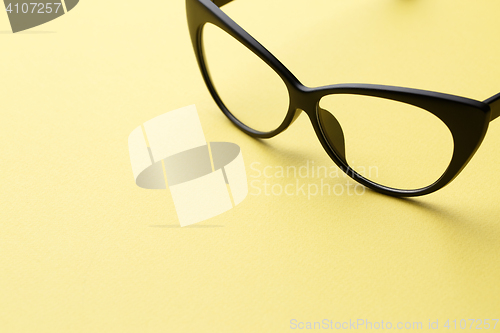 Image of Glasses in empty yellow background