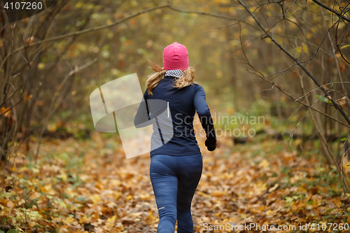 Image of Blonde sportswoman among yellow Leavs