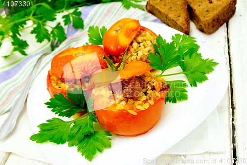 Image of Tomatoes stuffed with bulgur and meat in plate on light board