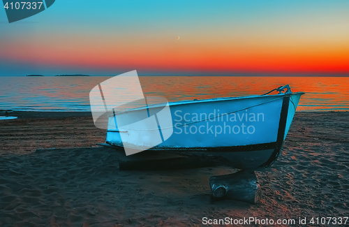 Image of Blue Boat On The Beach At Sunset 