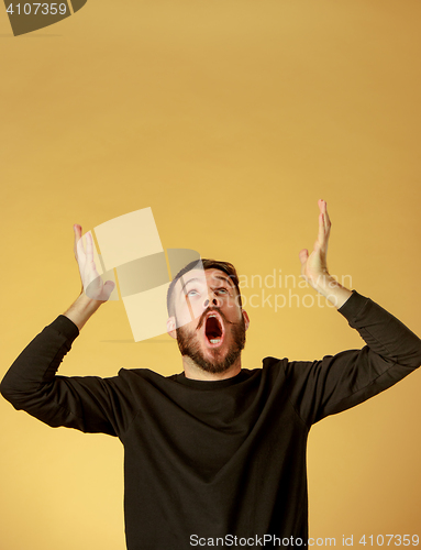 Image of Portrait of young man with shocked facial expression