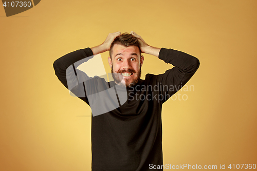 Image of Portrait of young man with shocked facial expression