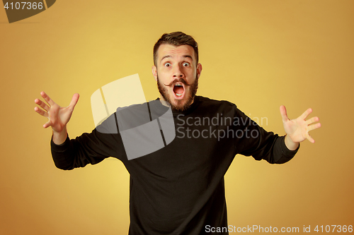 Image of Portrait of young man with shocked facial expression