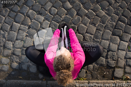 Image of woman  stretching before morning jogging