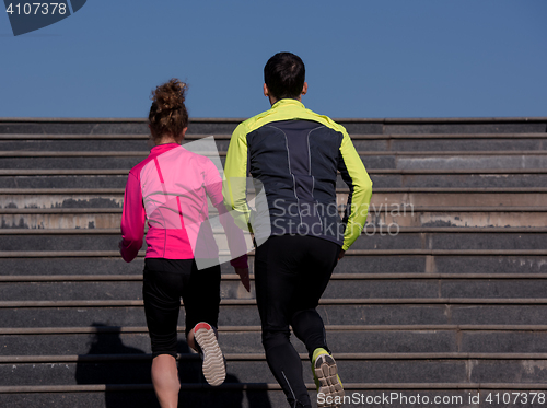 Image of young  couple jogging on steps