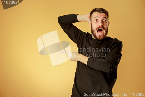 Image of Portrait of young man with shocked facial expression