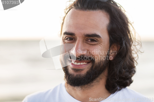 Image of happy smiling man with beard outdoors