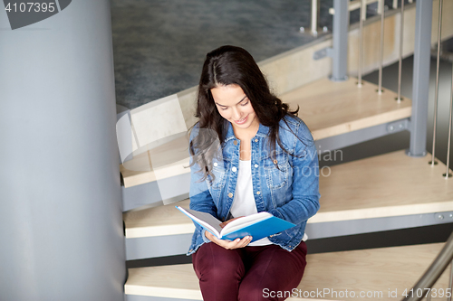 Image of high school student girl reading book on stairs