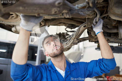 Image of mechanic man or smith repairing car at workshop