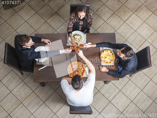 Image of Friends Clinking Wine Glasses at a Restaurant