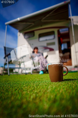 Image of Coffee Mug on grass. Family vacation travel, holiday trip in mot