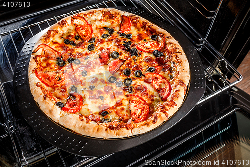 Image of Appetizing pizza in the oven.