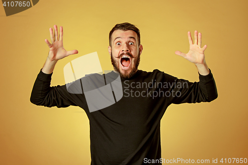 Image of Portrait of young man with shocked facial expression