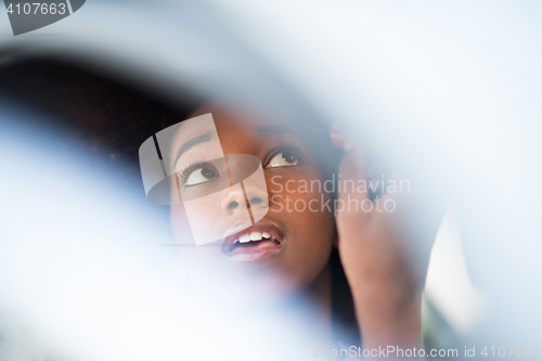 Image of woman making makeup while driving car