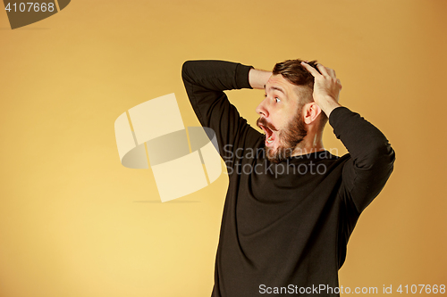 Image of Portrait of young man with shocked facial expression