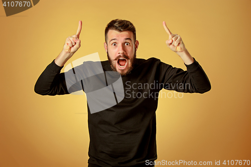 Image of Portrait of young man with shocked facial expression