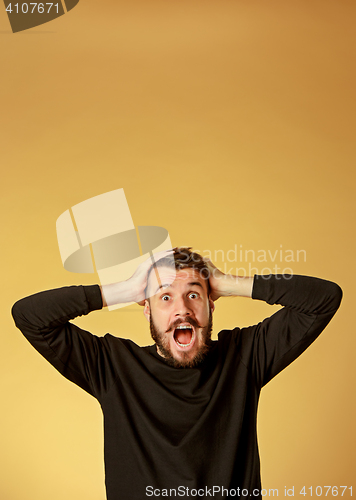 Image of Portrait of young man with shocked facial expression