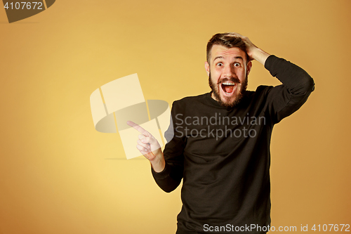 Image of Portrait of young man with shocked facial expression