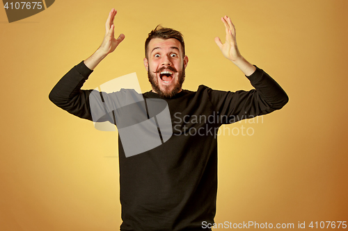 Image of The young happy man looking at camera