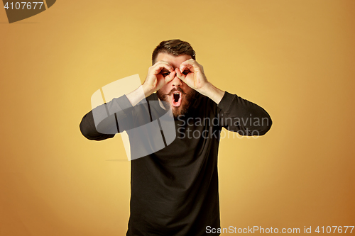 Image of Portrait of young man with shocked facial expression