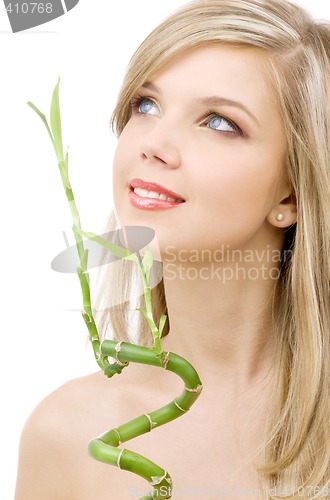 Image of blue-eyed blonde with bamboo