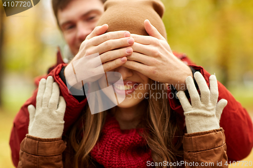 Image of happy young couple having fun in autumn park