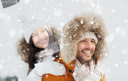 Image of happy couple having fun over winter background