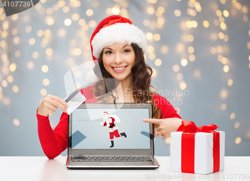 Image of woman in santa hat with laptop and credit card