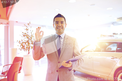 Image of happy man at auto show or car salon