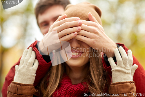 Image of happy young couple having fun in autumn park