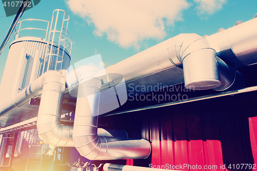 Image of Industrial zone, Steel pipelines and valves against blue sky