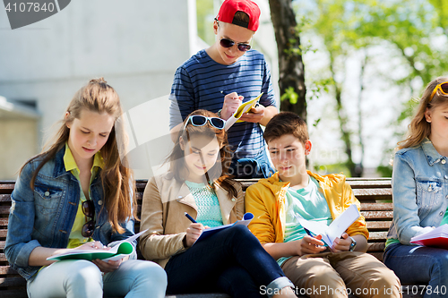 Image of group of students with notebooks at school yard