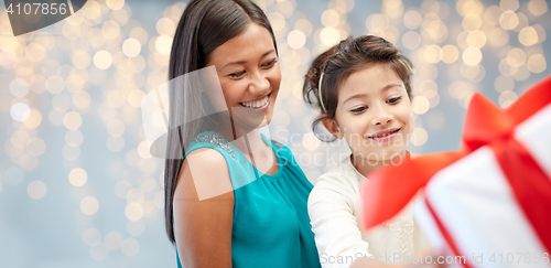 Image of happy mother and child girl with gift box