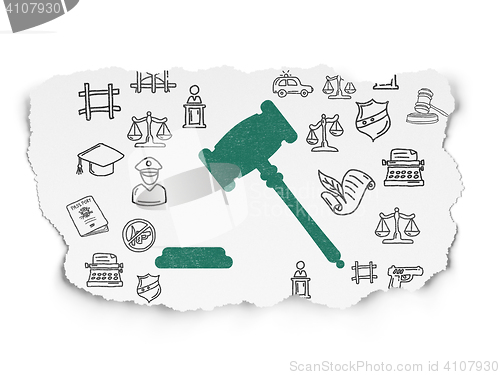 Image of Law concept: Gavel on Torn Paper background