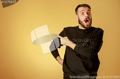 Image of Portrait of young man with shocked facial expression