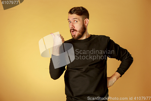 Image of Portrait of young man with shocked facial expression