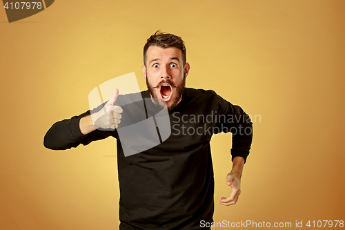 Image of Portrait of young man with shocked facial expression