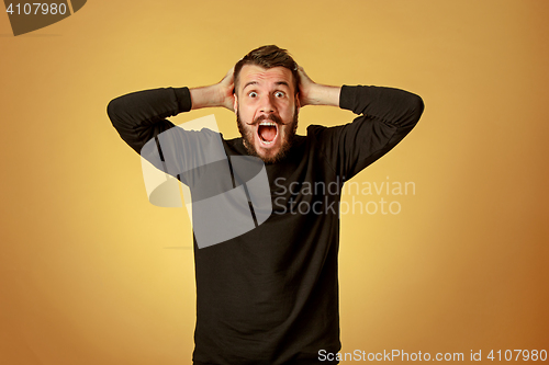 Image of Portrait of young man with shocked facial expression