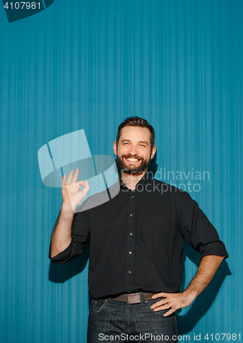 Image of Portrait of young man with happy facial expression