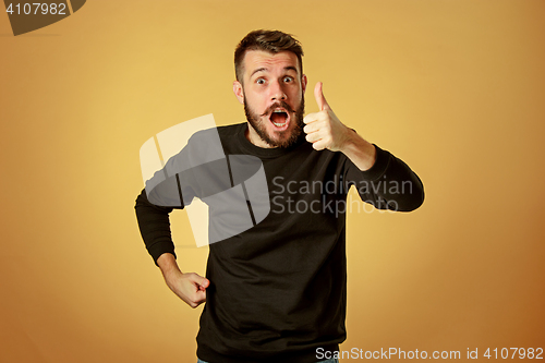 Image of The young happy man looking at camera
