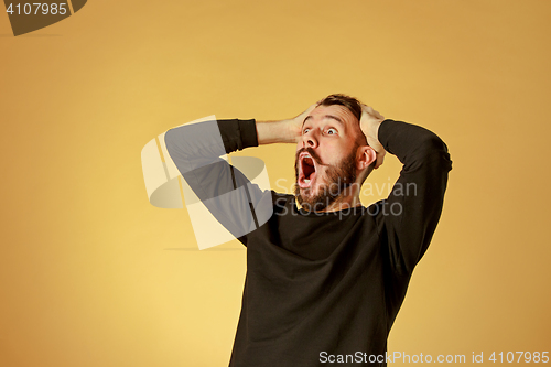 Image of Portrait of young man with shocked facial expression