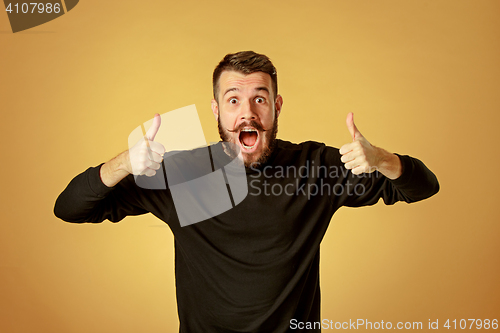 Image of Portrait of young man with shocked facial expression