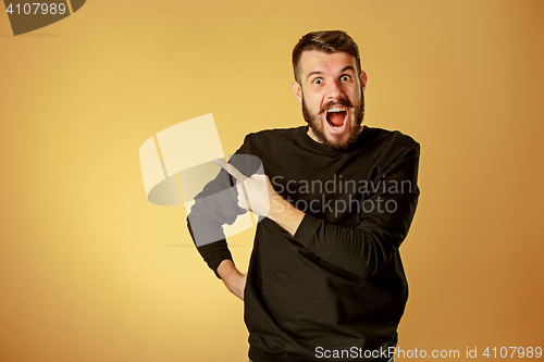 Image of Portrait of young man with shocked facial expression