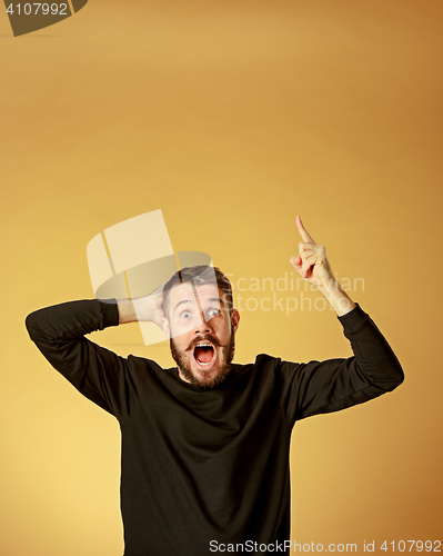 Image of Portrait of young man with shocked facial expression