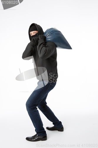 Image of Thief with bag on shoulder
