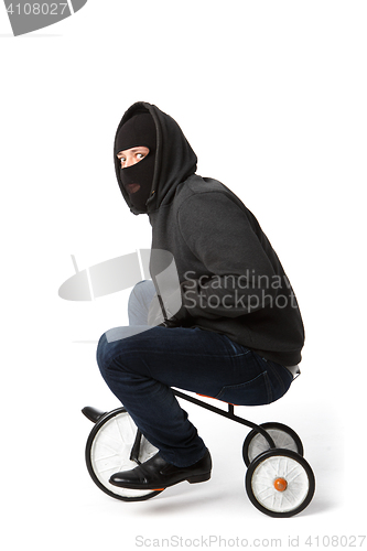 Image of Burglar in mask on bicycle