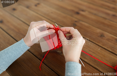 Image of woman hands knitting with needles and yarn