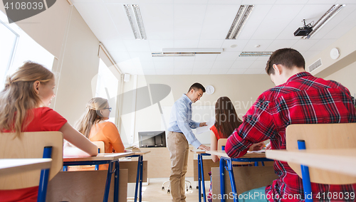 Image of group of students and teacher with test results